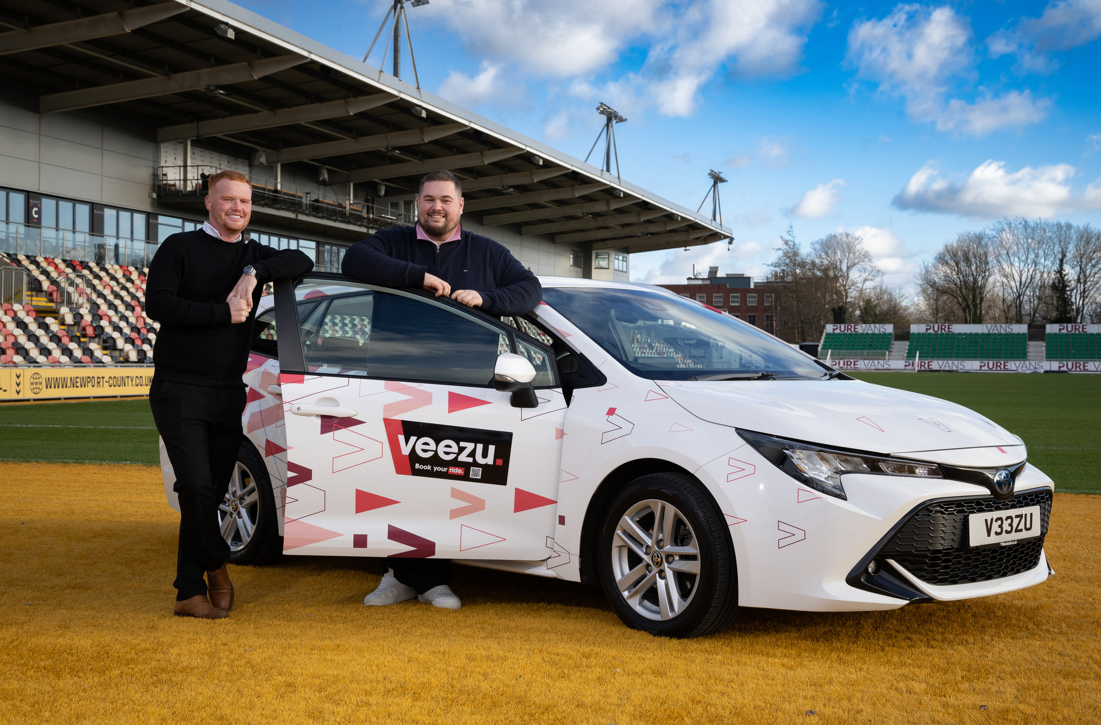 L-R Louis Cartwright-Walls, Newport County Media & Marketing Manager, David Watts, Dragons RFC Commercial Executive with Veezu car