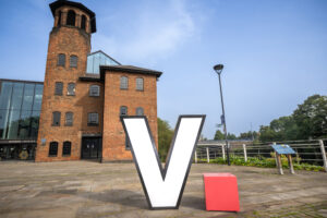 A white 'V' in front of a building