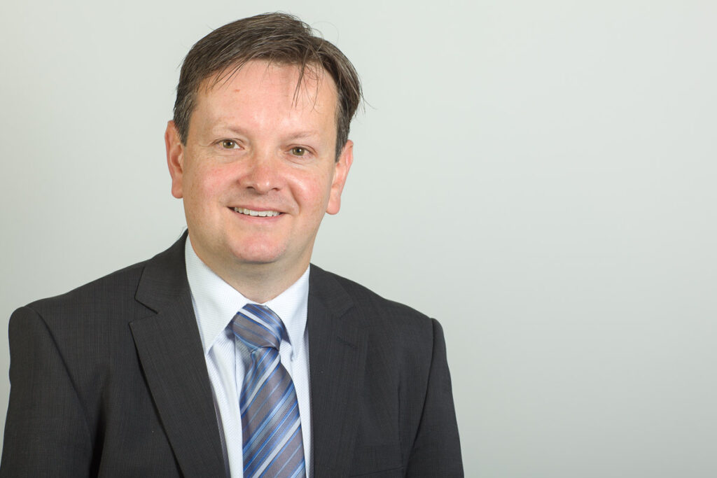 Man standing in front of grey background