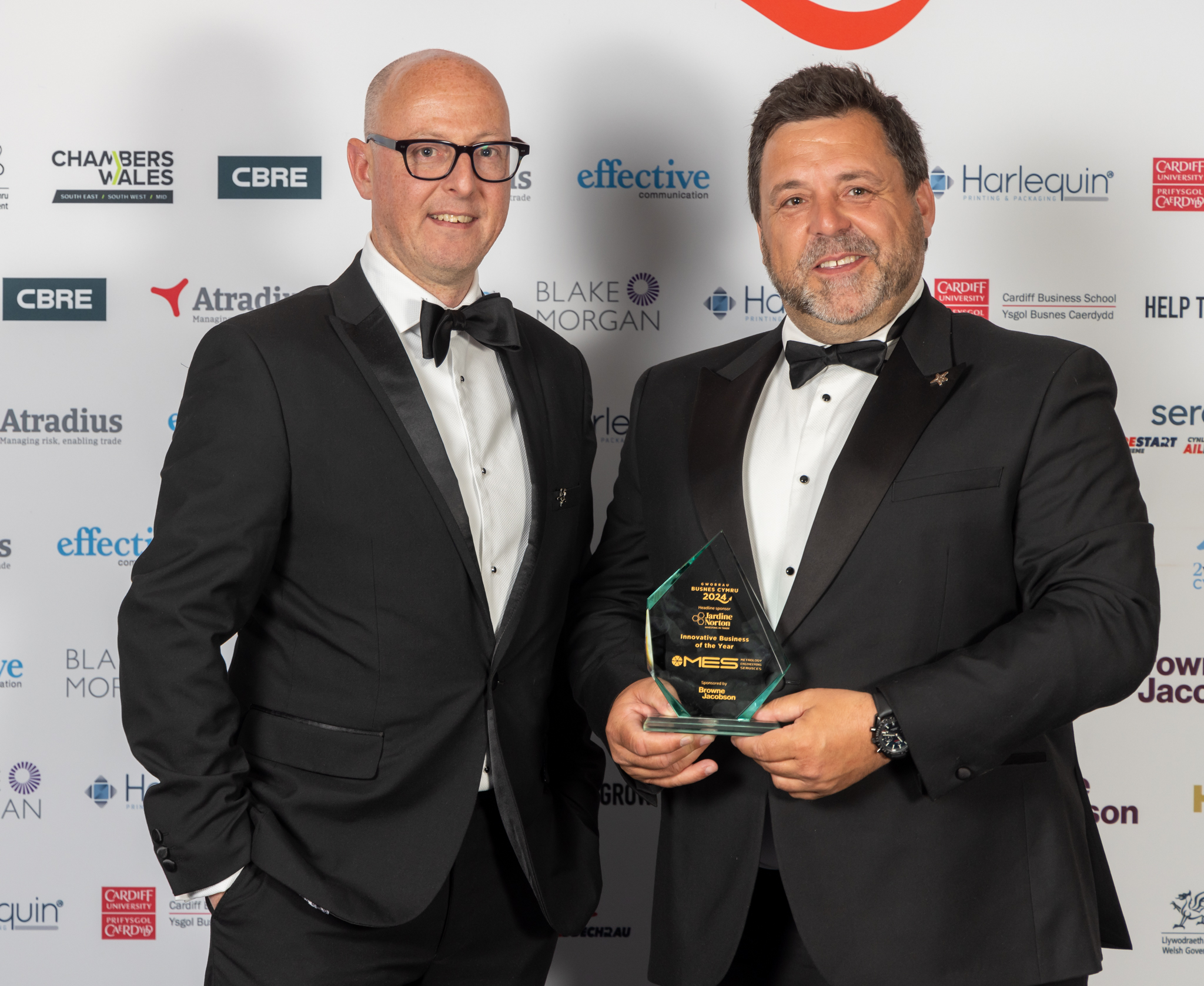 Two people standing with a award