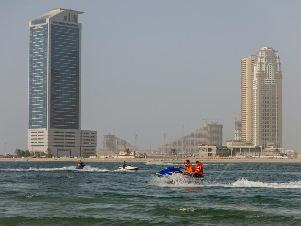 three people riding person watercraft during daytime