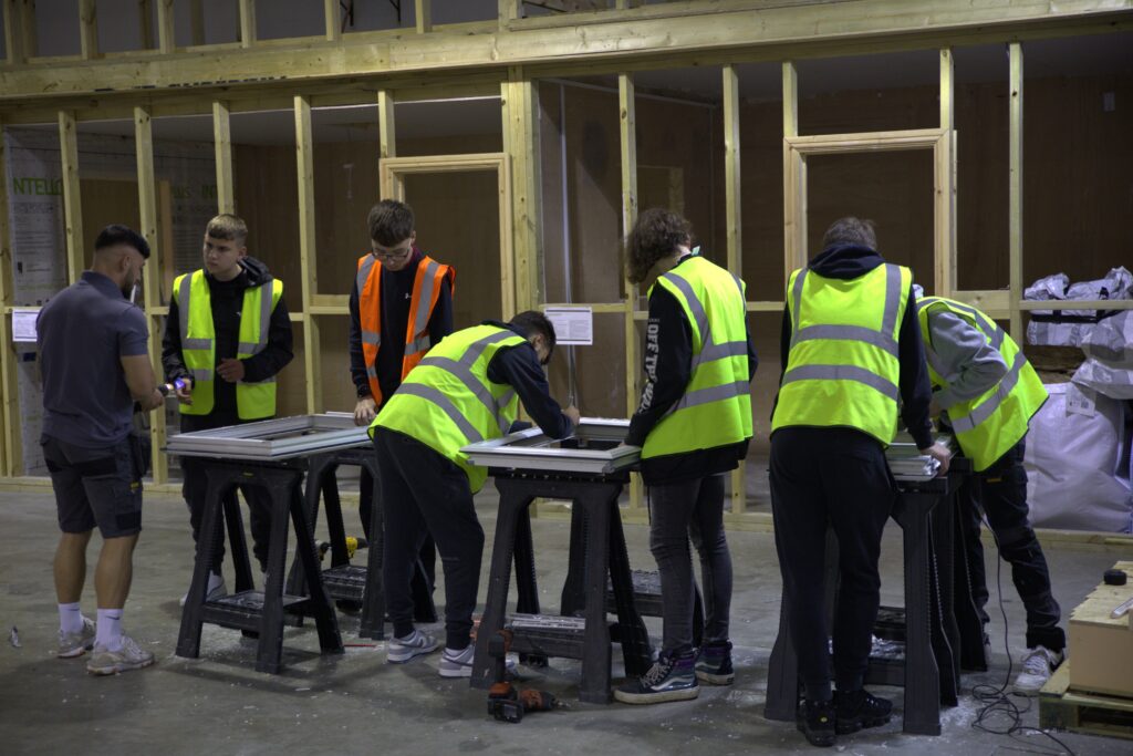 A group of apprentices working at CES wearing high vis jackets.